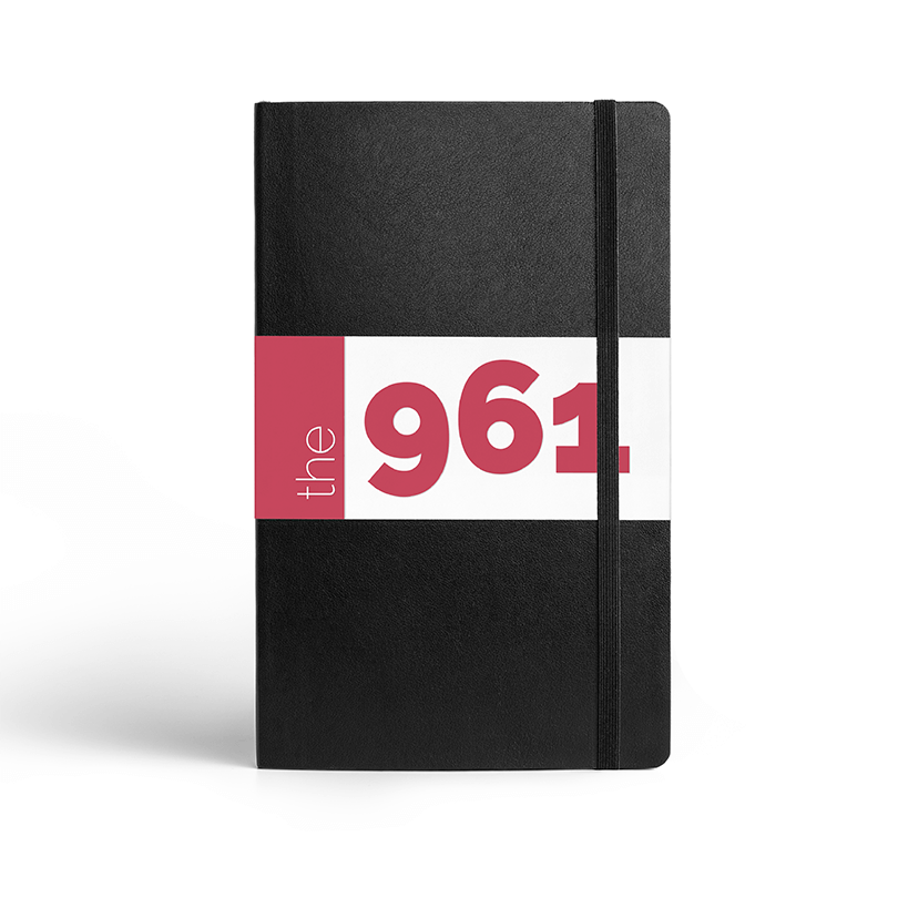 A mockup of the main logo design in it's bleed variation as a notebook cover.
